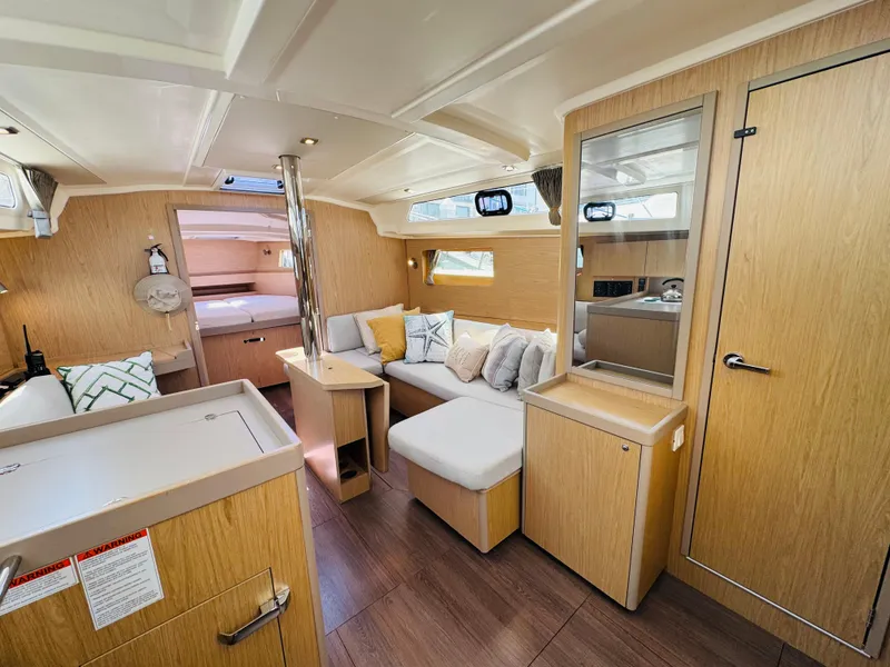 Slide: The Image of Modern interior of 2020 Beneteau Oceanis 41.1 yacht with cozy seating and wood finish. - 27