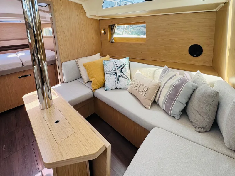 Slide: The Image of Interior of 2020 Beneteau Oceanis 41.1 yacht with cozy seating and decorative pillows. - 28