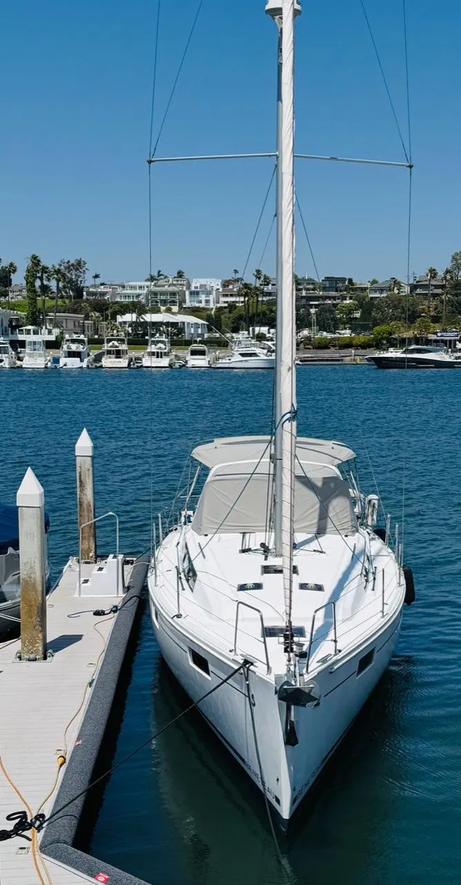 Slide: The Image of 2020 Beneteau Oceanis 41.1 sailboat docked in a marina under clear blue skies. - 3