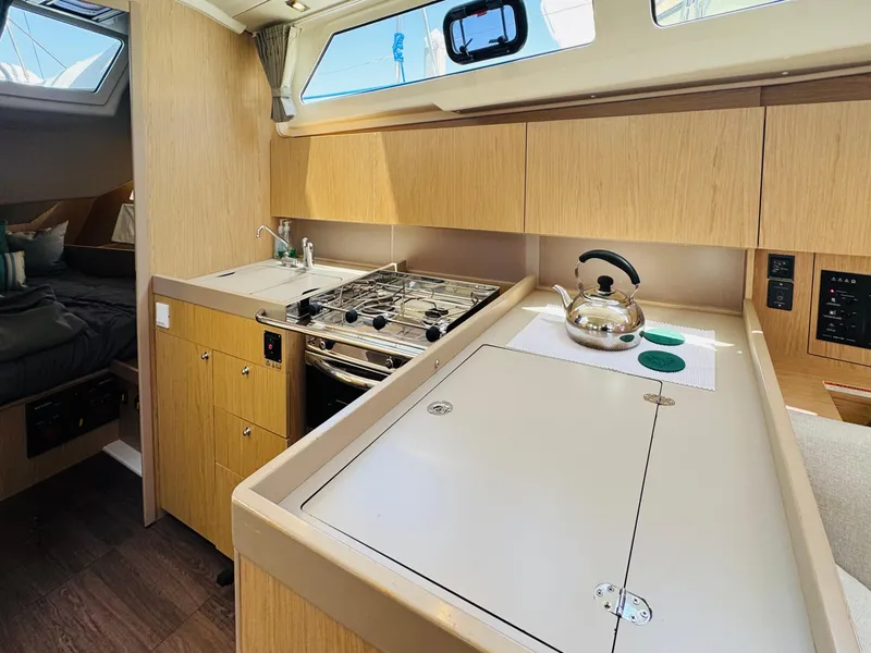 Slide: The Image of Interior of 2020 Beneteau Oceanis 41.1 yacht kitchen with stove and kettle. - 31