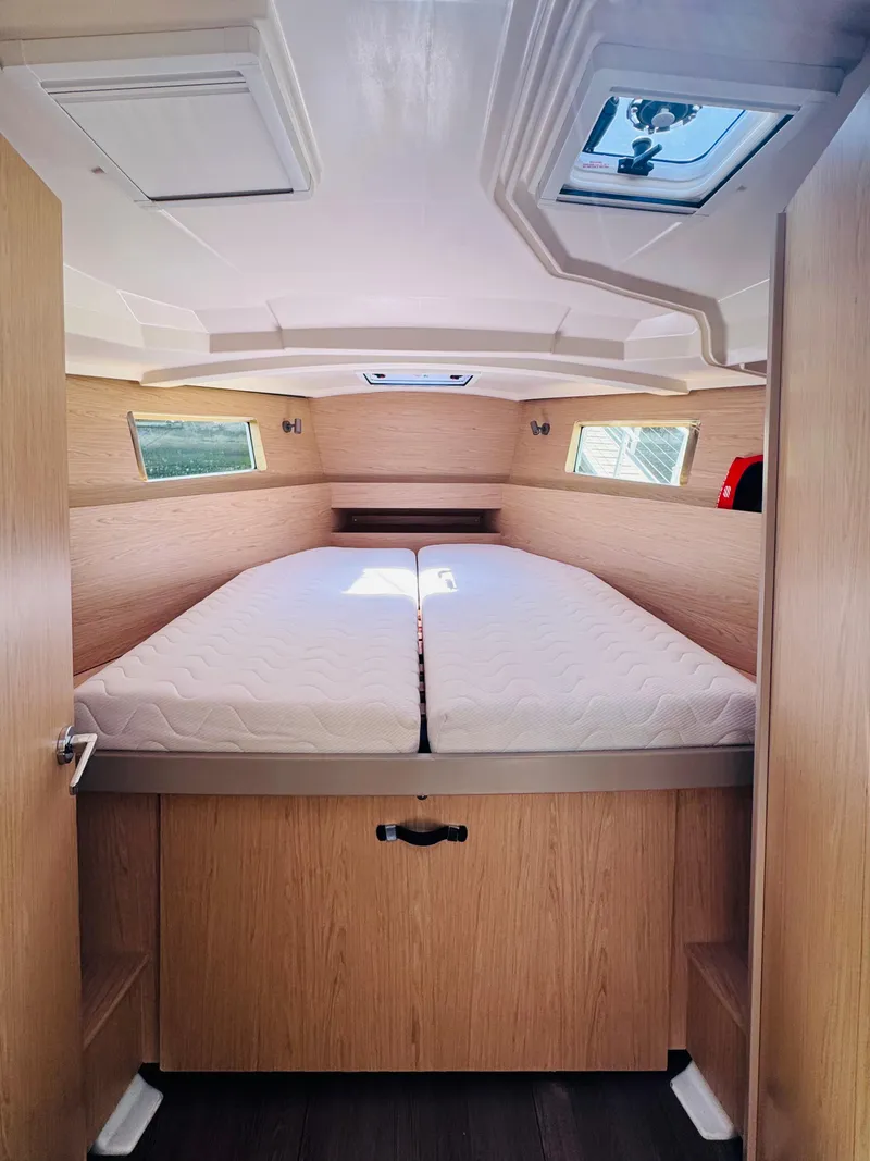 Slide: The Image of 2020 Beneteau Oceanis 41.1 cabin interior with double bed and natural wood finish. - 32