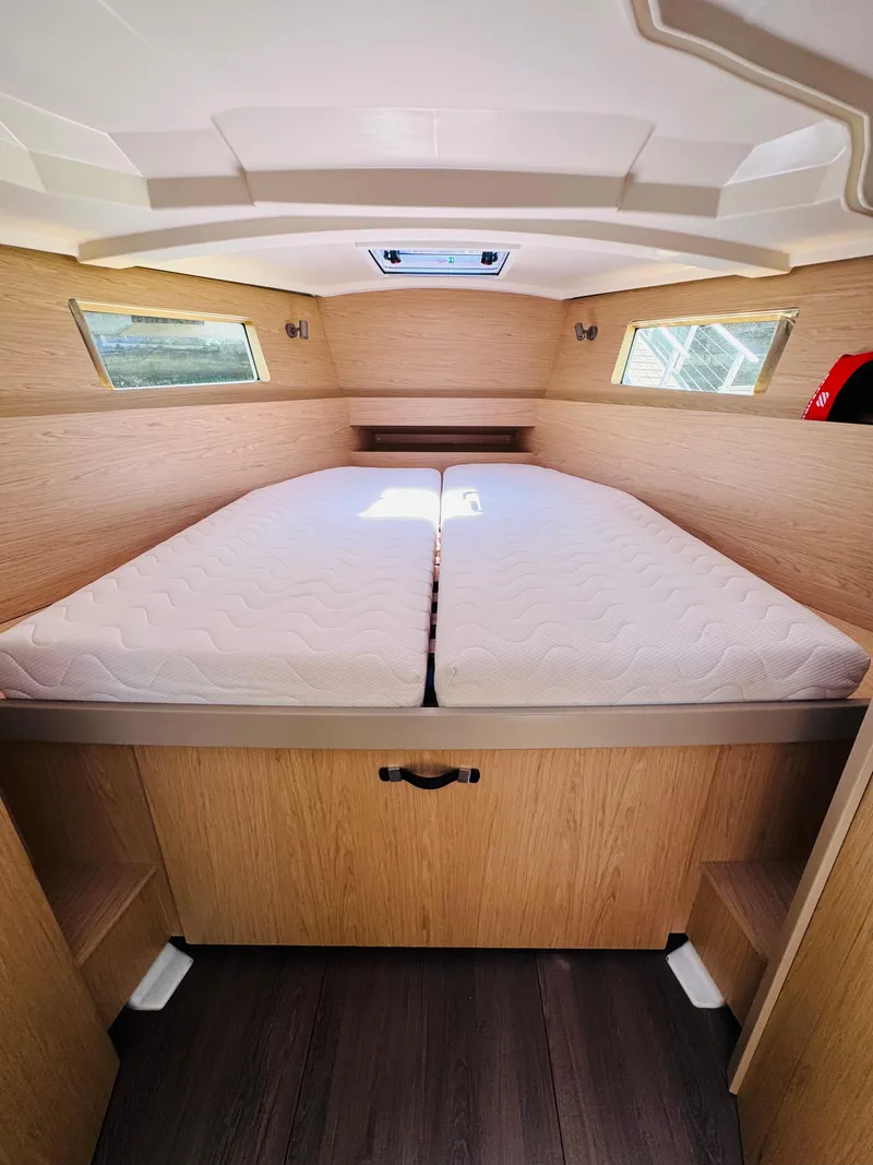 Slide: The Image of Interior cabin of 2020 Beneteau Oceanis 41.1 yacht with double bed and wooden finish. - 33
