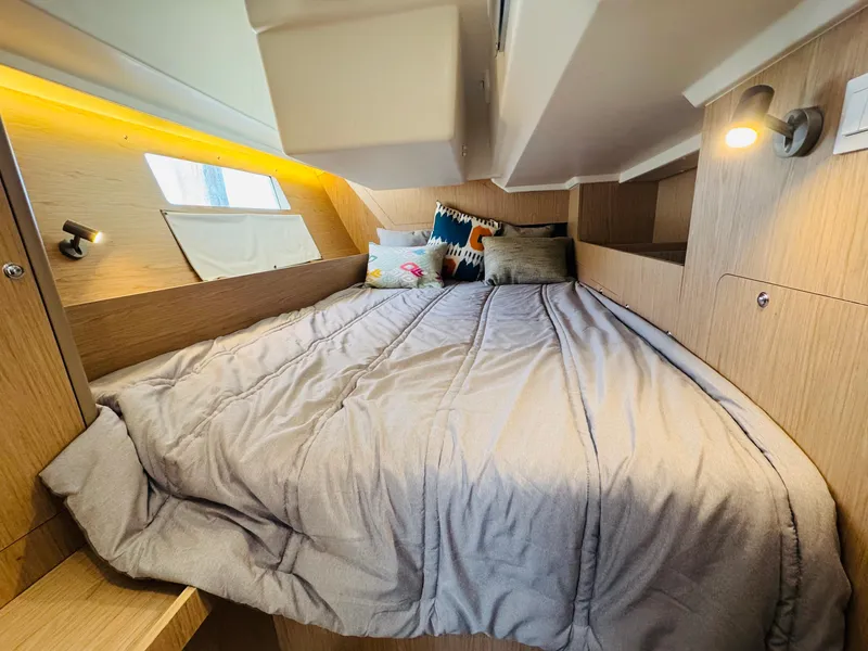 Slide: The Image of Cozy cabin interior of 2020 Beneteau Oceanis 41.1 sailboat with comfortable bedding. - 38