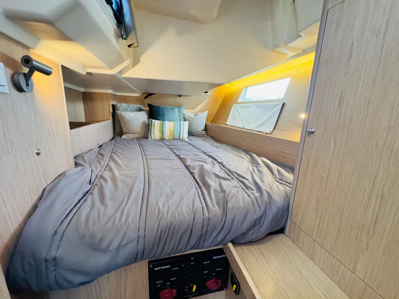 Slide: The Image of Cozy cabin interior of 2020 Beneteau Oceanis 41.1 with modern bedding and ambient lighting. - 39