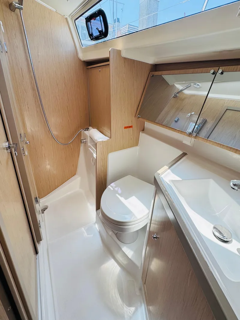 Slide: The Image of 2020 Beneteau Oceanis 41.1 yacht bathroom with modern fixtures and wood accents. - 41