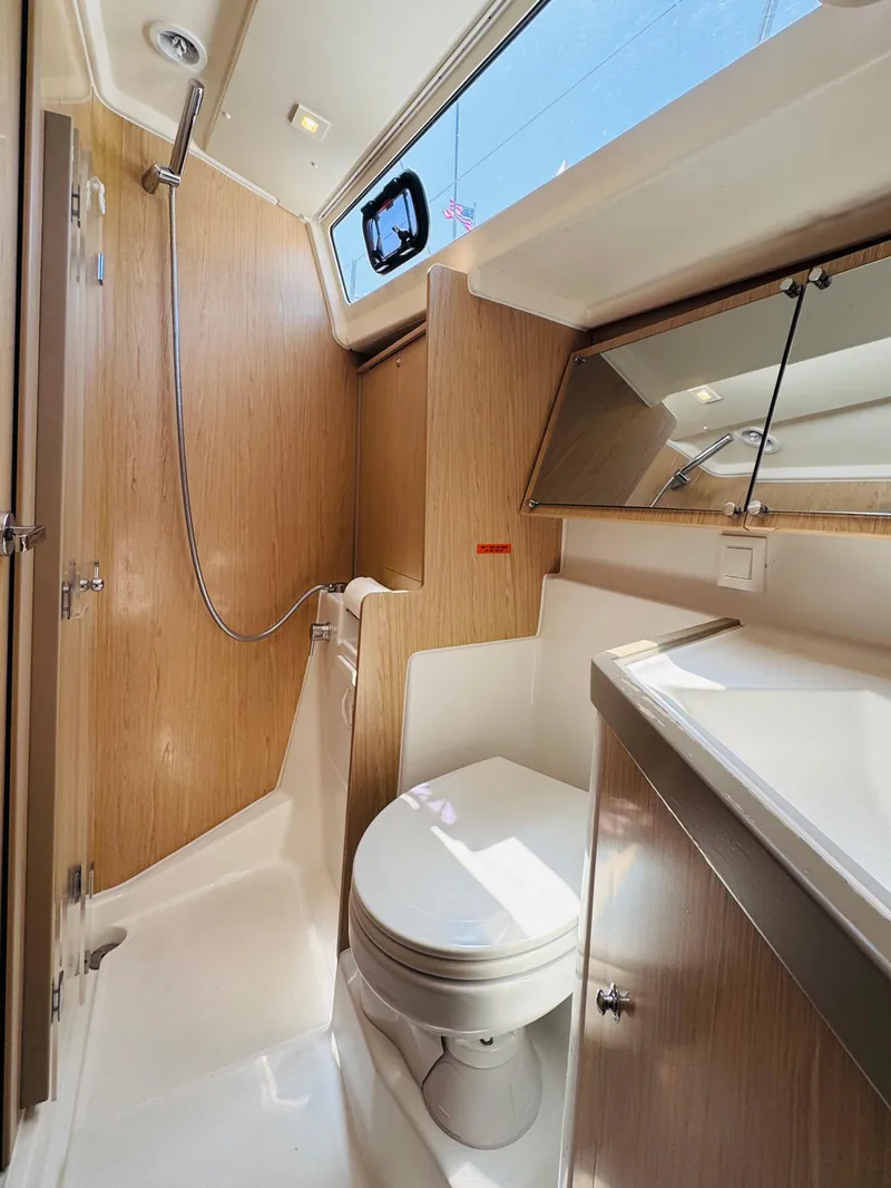 Slide: The Image of 2020 Beneteau Oceanis 41.1 yacht bathroom with modern fixtures and wood accents. - 42