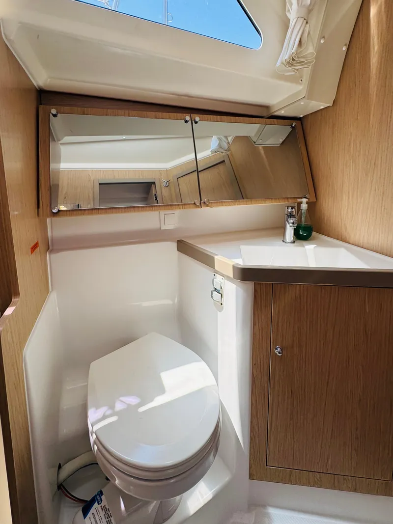 Slide: The Image of Beneteau Oceanis 41.1 2020 yacht bathroom with wooden cabinetry and skylight. - 43