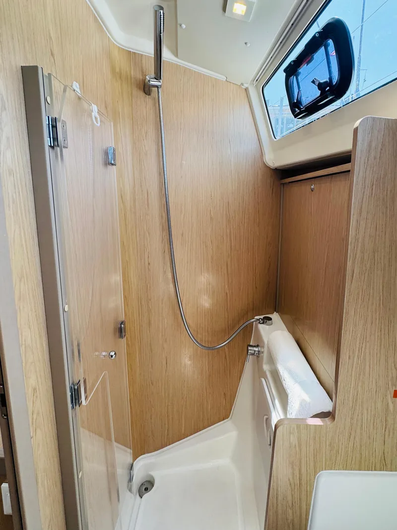 Slide: The Image of 2020 Beneteau Oceanis 41.1 yacht shower with wood paneling and modern fixtures. - 44