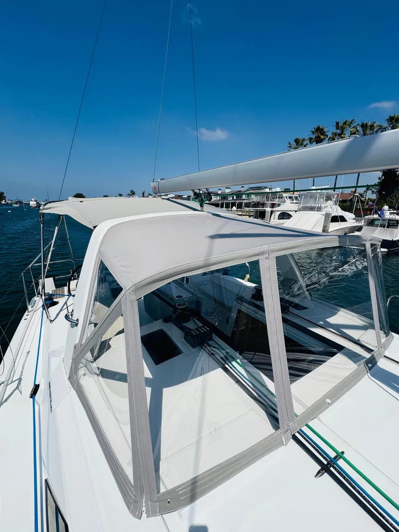 Slide: The Image of 2020 Beneteau Oceanis 41.1 sailboat with canopy, docked in a sunny marina. - 8