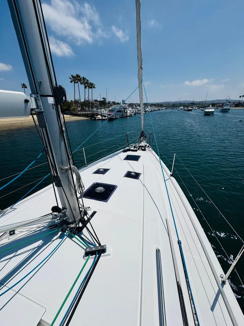Slide: The Image of 2020 Beneteau Oceanis 41.1 sailboat on calm water near a marina. - 9