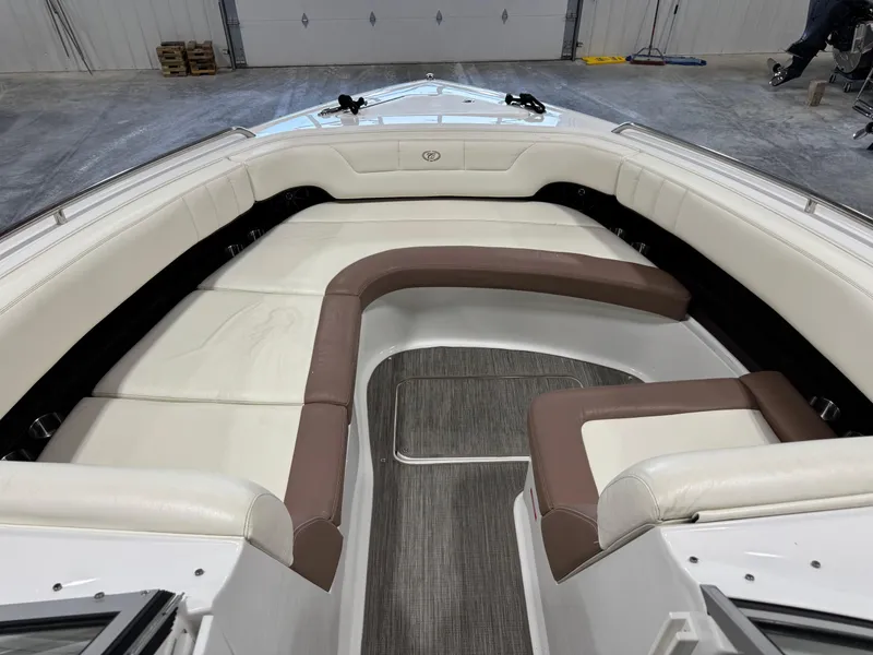 Slide: The Image of 2012 Cobalt 296 BR boat interior with white and brown seating in a spacious layout. - 10