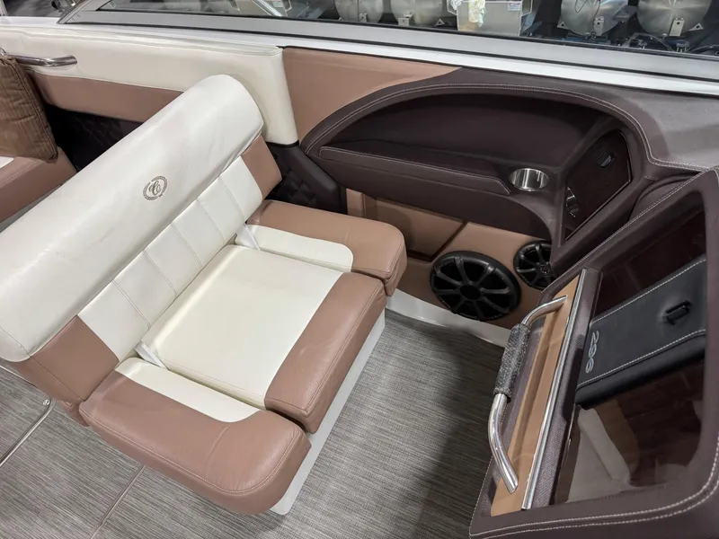 Slide: The Image of 2012 Cobalt 296 BR boat interior with beige and white seating, modern dashboard, and speaker system. - 12