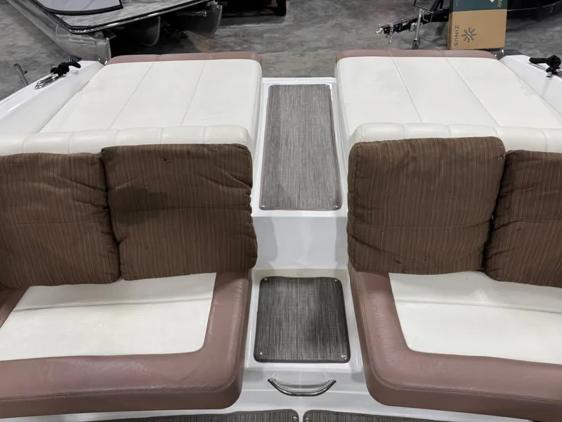 Slide: The Image of 2012 Cobalt 296 BR boat interior with cushioned seating and textured flooring. - 7