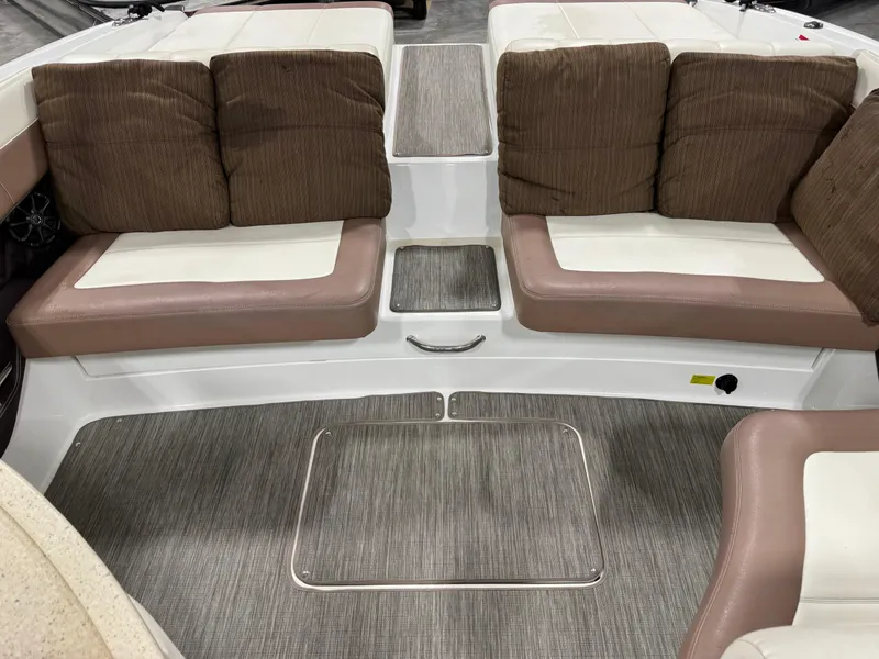 Slide: The Image of 2012 Cobalt 296 BR boat interior with cushioned seating and carpeted flooring. - 8
