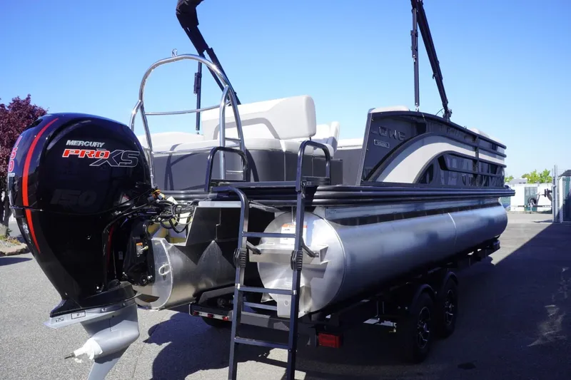 Slide: The Image of 2025 Lowe SS 230 DL pontoon boat with Mercury Pro XS engine, parked outdoors. - 10