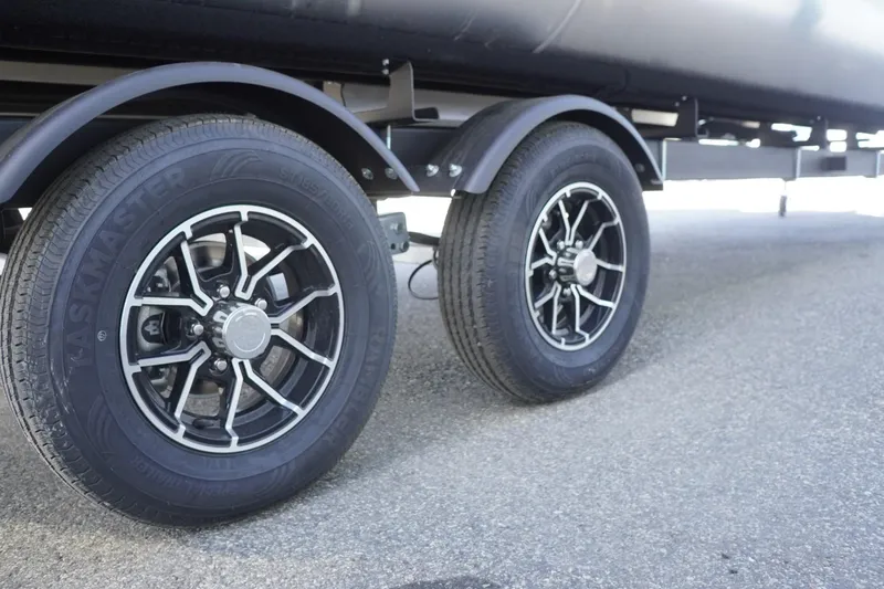 Slide: The Image of Trailer wheels of a 2025 Lowe SS 230 DL on pavement. - 12