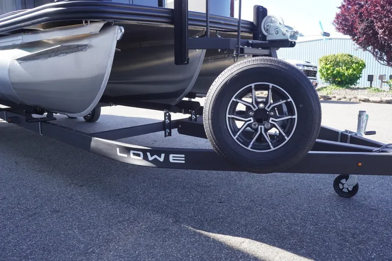 Slide: The Image of 2025 Lowe SS 230 DL boat on trailer, featuring sleek design and modern wheel. - 14