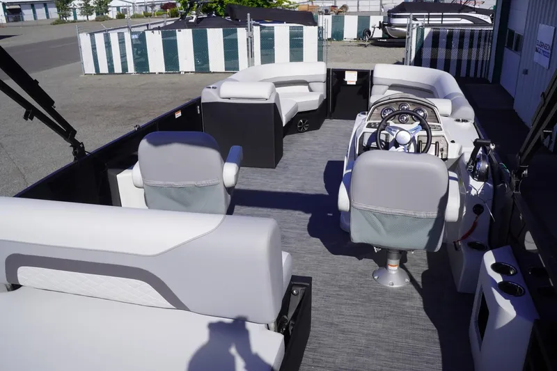 Slide: The Image of Interior of 2025 Lowe SS 230 DL pontoon boat with modern seating and steering console. - 18