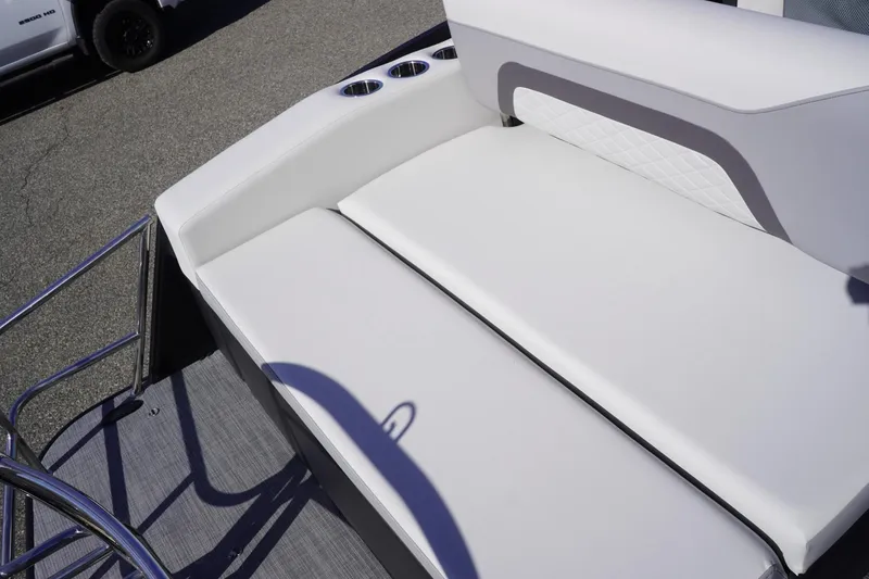 Slide: The Image of 2025 Lowe SS 230 DL boat with white cushioned seating and cup holders. - 19