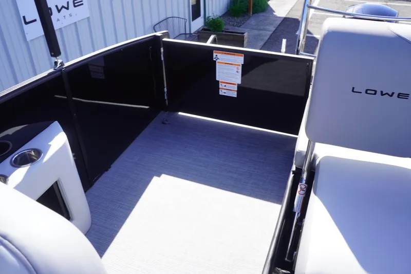 Slide: The Image of 2025 Lowe SS 230 DL boat interior with seating and cup holder, showcasing modern design. - 23