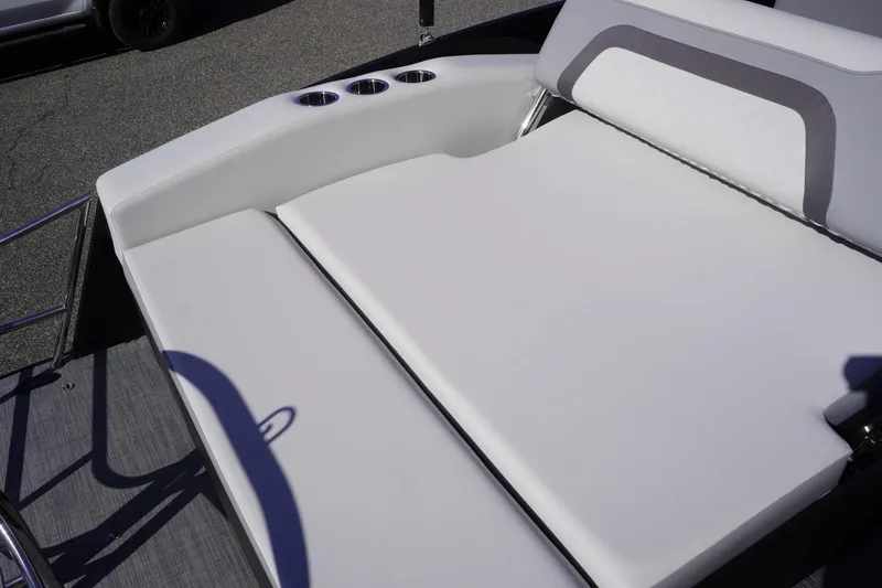 Slide: The Image of 2025 Lowe SS 230 DL boat with white cushioned seating and cup holders. - 25