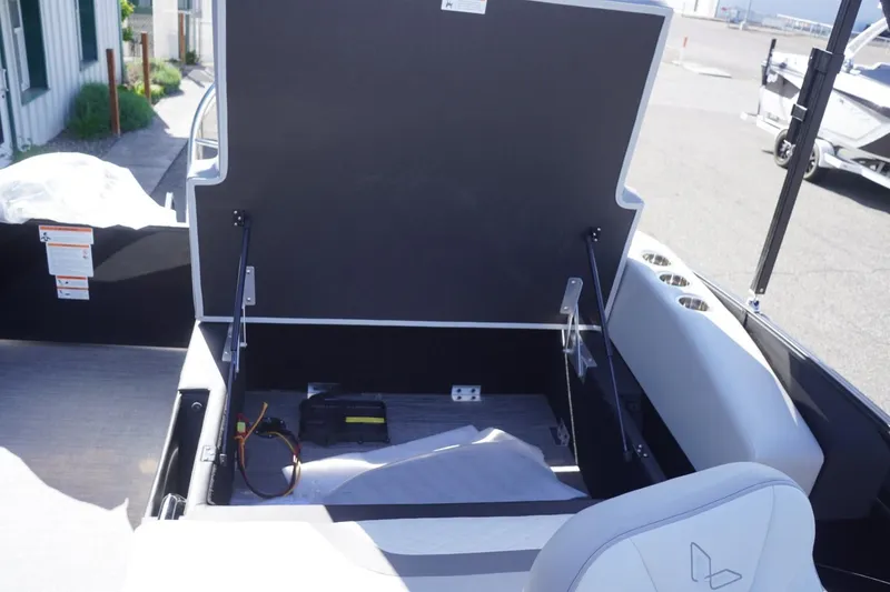 Slide: The Image of Open storage compartment on 2025 Lowe SS 230 DL boat, showing interior space and equipment. - 26