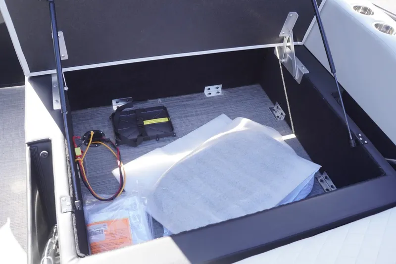 Slide: The Image of Open storage compartment in 2025 Lowe SS 230 DL boat, showing interior contents. - 27