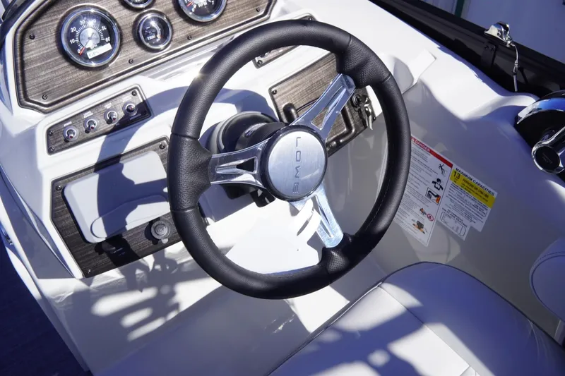 Slide: The Image of Steering wheel and dashboard of 2025 Lowe SS 230 DL boat. - 36