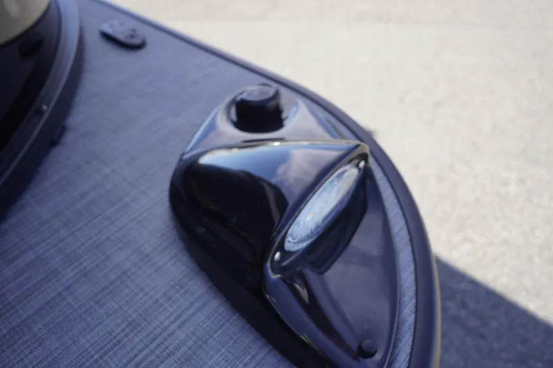 Slide: The Image of Close-up of a 2025 Lowe SS 230 DL boat's navigation light on a textured surface. - 42