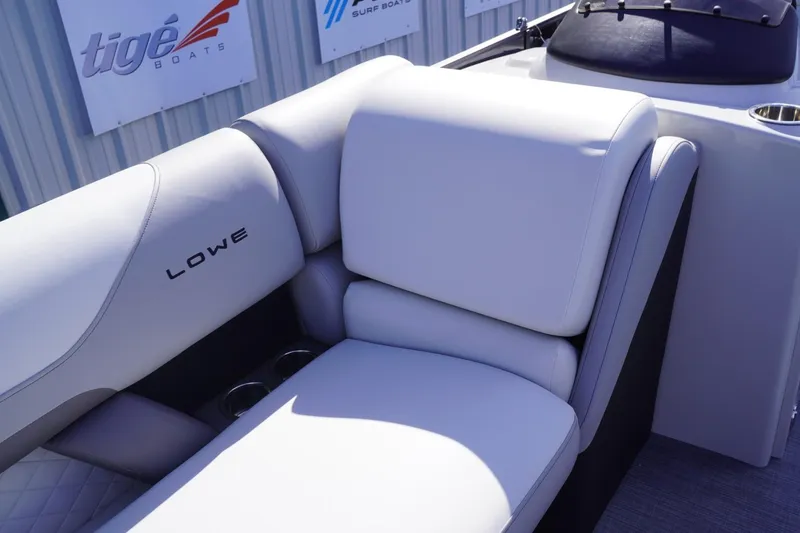 Slide: The Image of 2025 Lowe SS 230 DL boat interior with plush white seating and cup holders. - 45