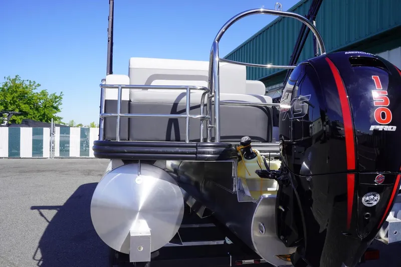 Slide: The Image of 2025 Lowe SS 230 DL pontoon boat with 150 Pro motor, parked outdoors. - 8