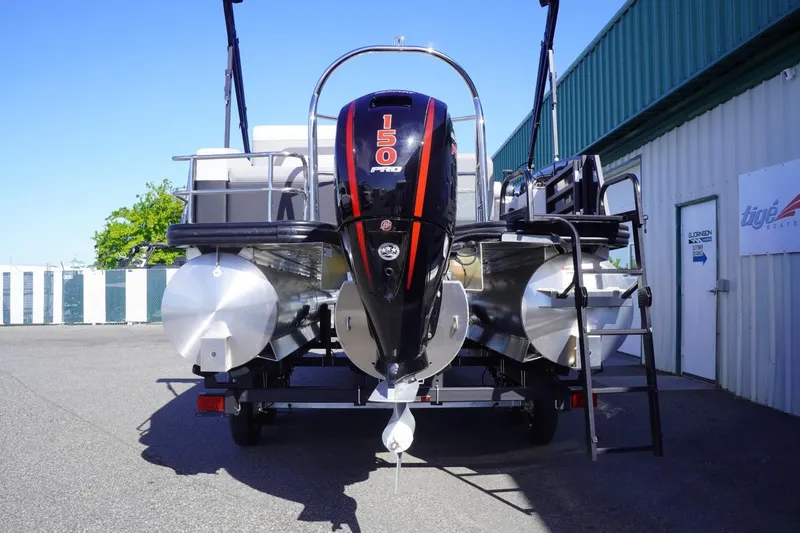 Slide: The Image of 2025 Lowe SS 230 DL pontoon boat with 150 Pro motor, parked outdoors. - 9