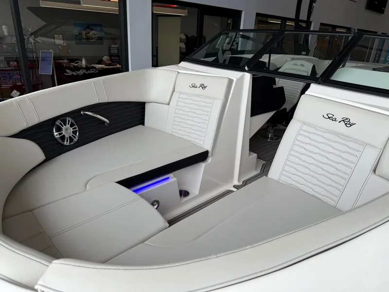 Slide: The Image of 2024 Sea Ray SPX230 boat interior with white leather seating and modern design. - 13