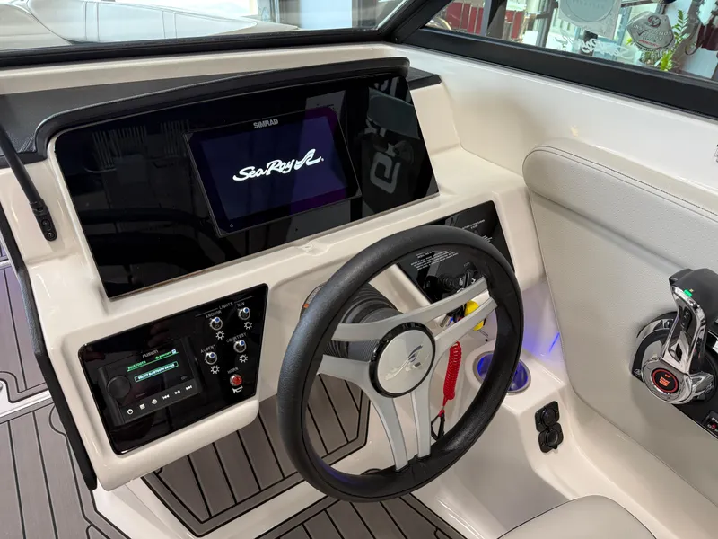 Slide: The Image of 2024 Sea Ray SPX230 dashboard with steering wheel and control panel. - 29