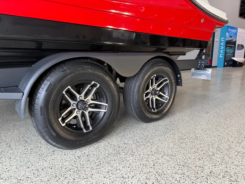 Slide: The Image of 2024 Sea Ray SPX230 boat trailer with dual wheels, red and black design. - 3