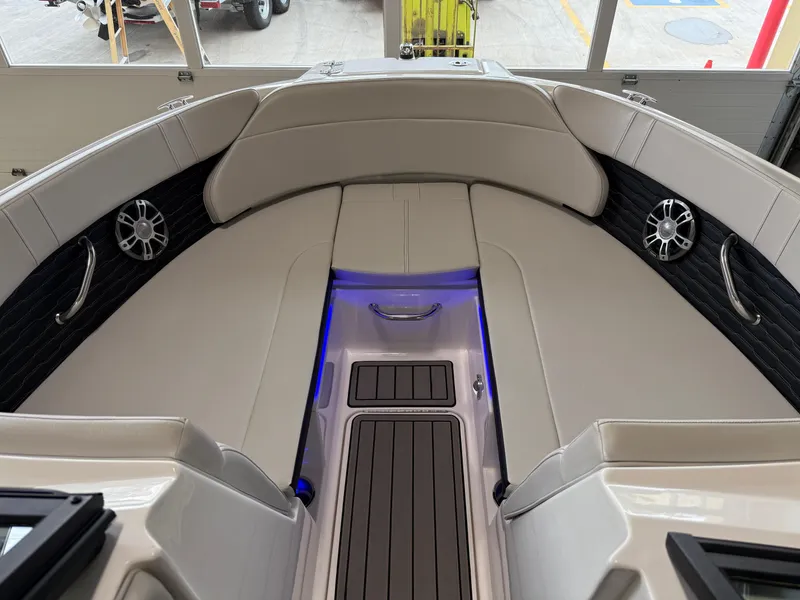 Slide: The Image of 2024 Sea Ray SPX230 boat interior with beige seating and blue accent lighting. - 31