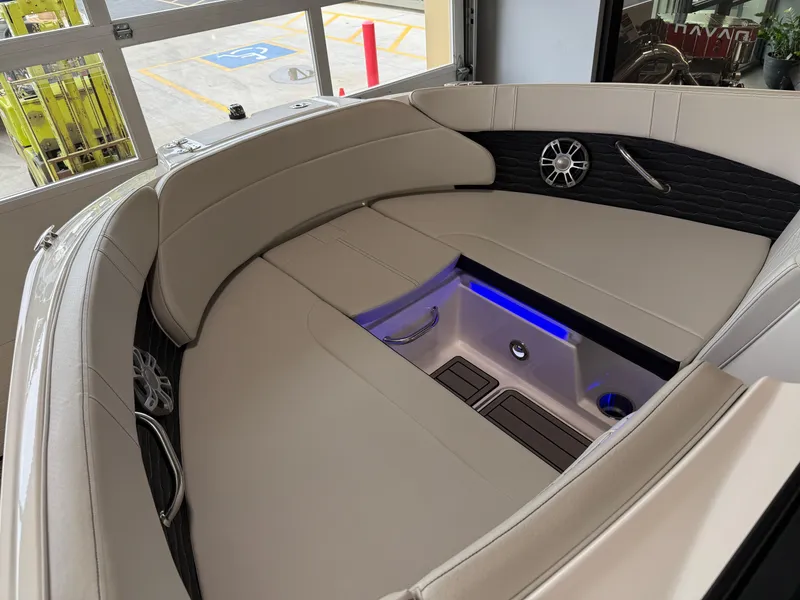 Slide: The Image of 2024 Sea Ray SPX230 boat interior with cushioned seating and ambient lighting. - 32