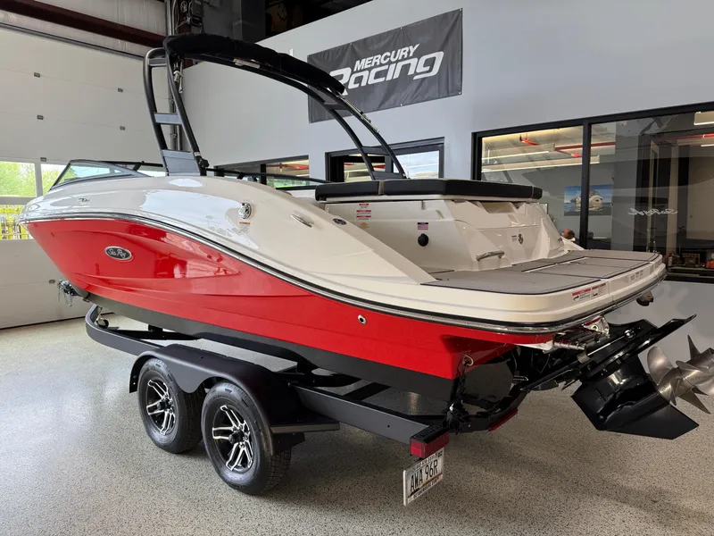 Slide: The Image of 2024 Sea Ray SPX230 boat with red and white exterior on a trailer in a showroom. - 4