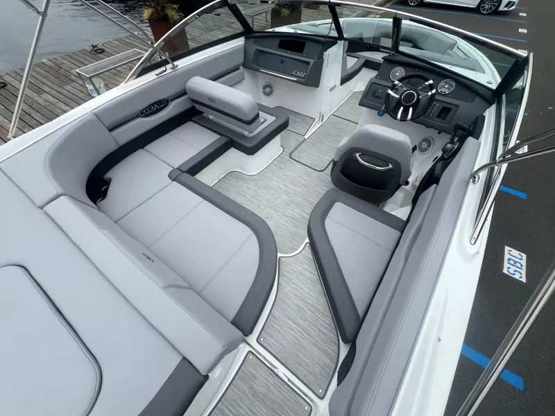 Slide: The Image of 2023 Cobalt CS22 boat interior with sleek seating and modern dashboard design. - 11