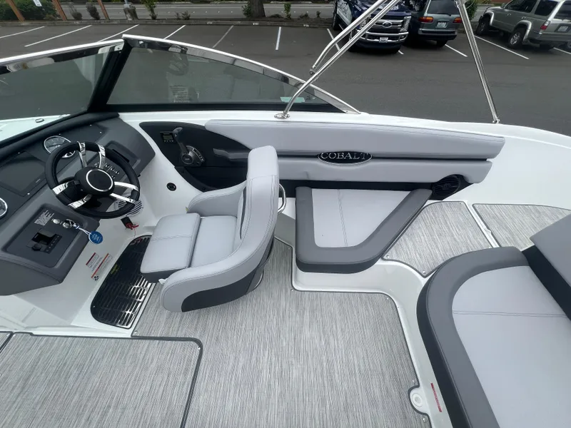 Slide: The Image of 2023 Cobalt CS22 boat interior with sleek steering wheel and comfortable seating. - 12