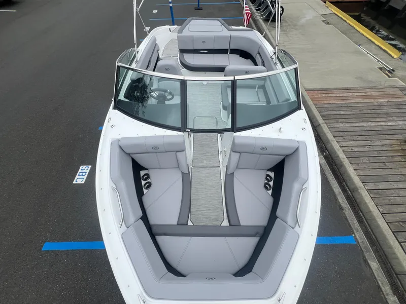 Slide: The Image of 2023 Cobalt CS22 boat with sleek design and spacious seating, docked at a marina. - 20