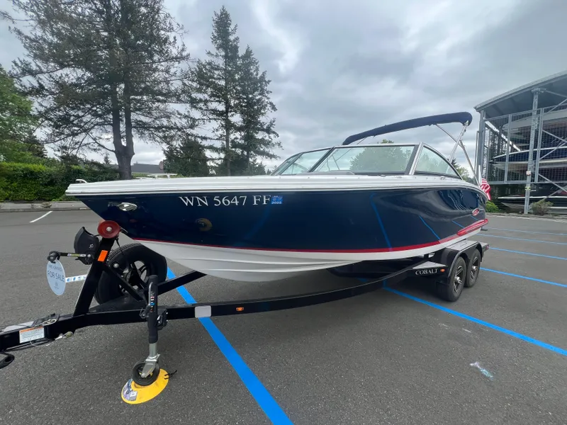 Slide: The Image of 2023 Cobalt CS22 boat on trailer in parking lot, overcast sky. - 4
