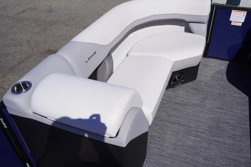 Slide: The Image of 2025 Lowe SS 230 DL boat interior with white cushioned seating and cup holder. - 23