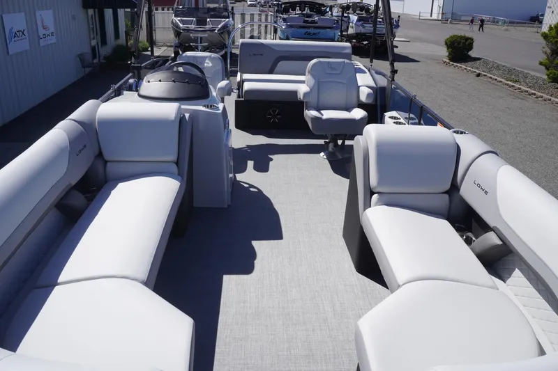 Slide: The Image of 2025 Lowe SS 230 DL pontoon boat with spacious seating and modern design. - 27