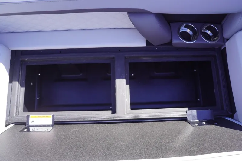 Slide: The Image of Open storage compartment in 2025 Lowe SS 230 DL boat interior. - 31
