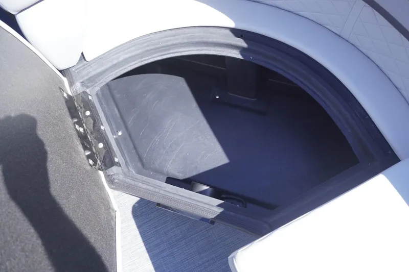 Slide: The Image of Open storage compartment in 2025 Lowe SS 230 DL boat interior. - 32