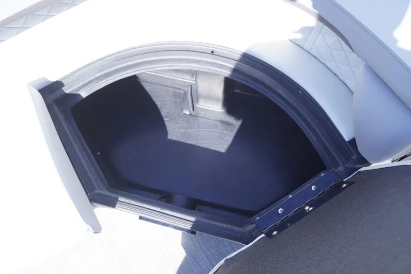 Slide: The Image of Storage compartment on a 2025 Lowe SS 230 DL boat, featuring cushioned seating. - 33