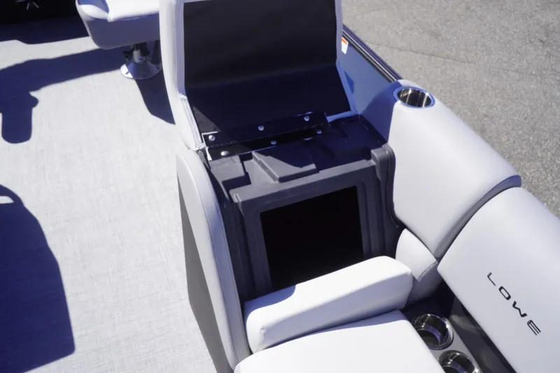 Slide: The Image of 2025 Lowe SS 230 DL boat interior with open storage compartment and cup holders. - 35