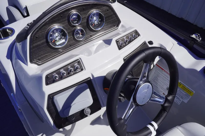 Slide: The Image of 2025 Lowe SS 230 DL boat dashboard with steering wheel and control gauges. - 40
