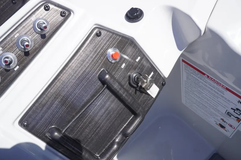 Slide: The Image of Control panel of a 2025 Lowe SS 230 DL boat with ignition and switches. - 43